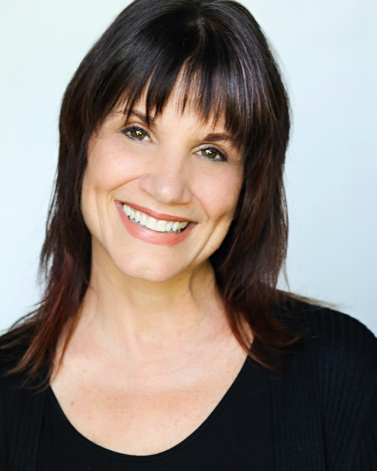 Photo of woman with dark hair and black shirt