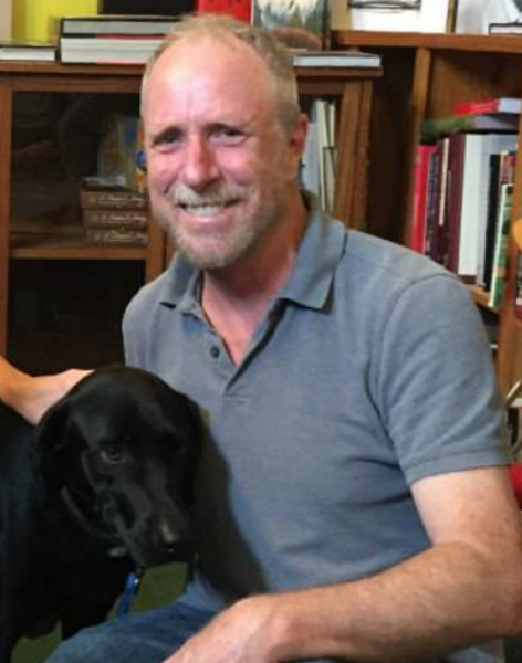 Author Alan Huffman posing with his dog, Girl Dog
