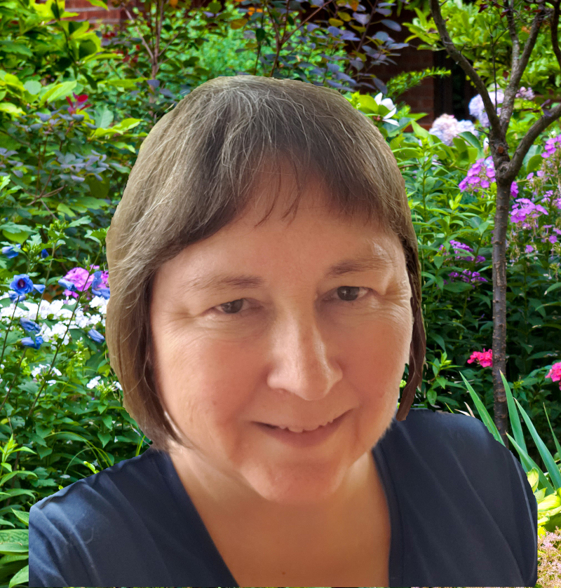 headshot of author Maggie Lynch in her backyard garden