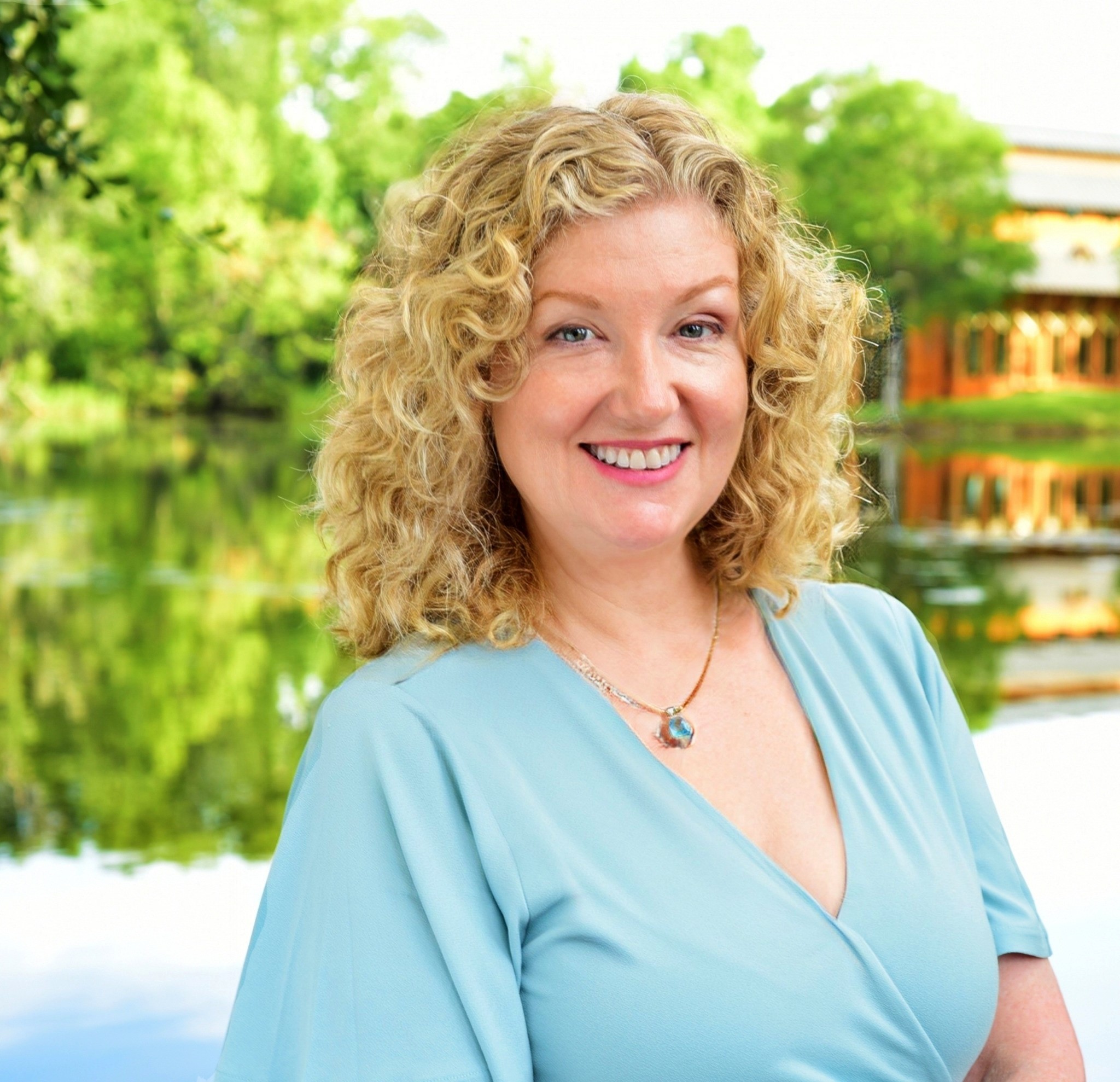 author Barbara Drake-Vera standing by a lake in Florida