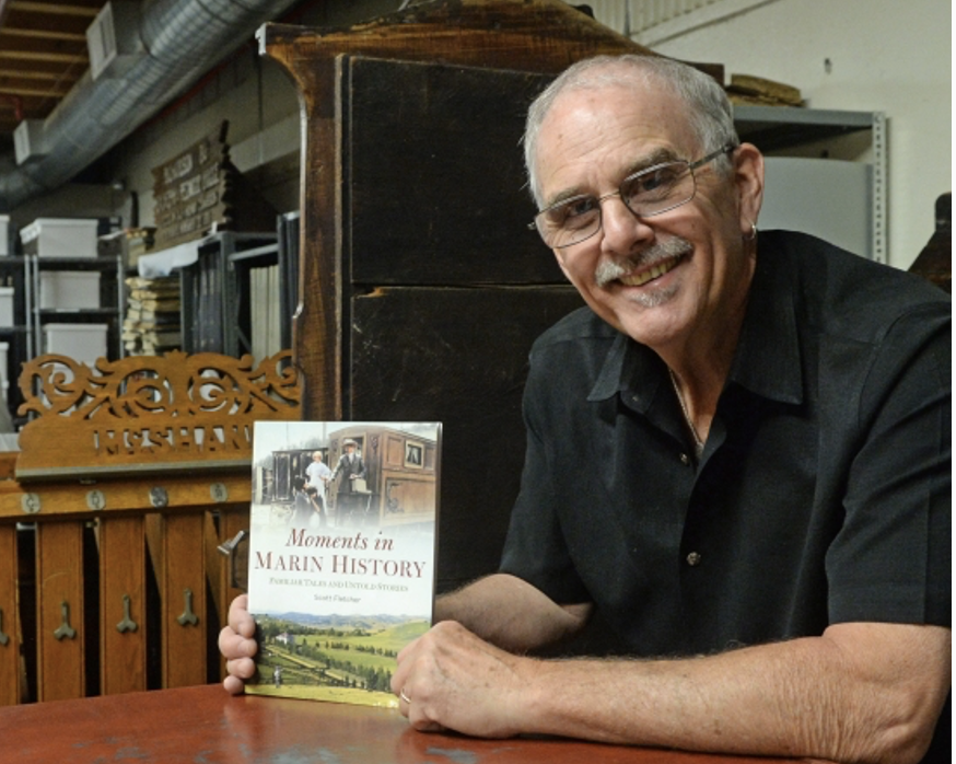 Photo of author, Scott Fletcher holding his book, Moments in Marin History at the Marin History Museum facility in Novato, CA