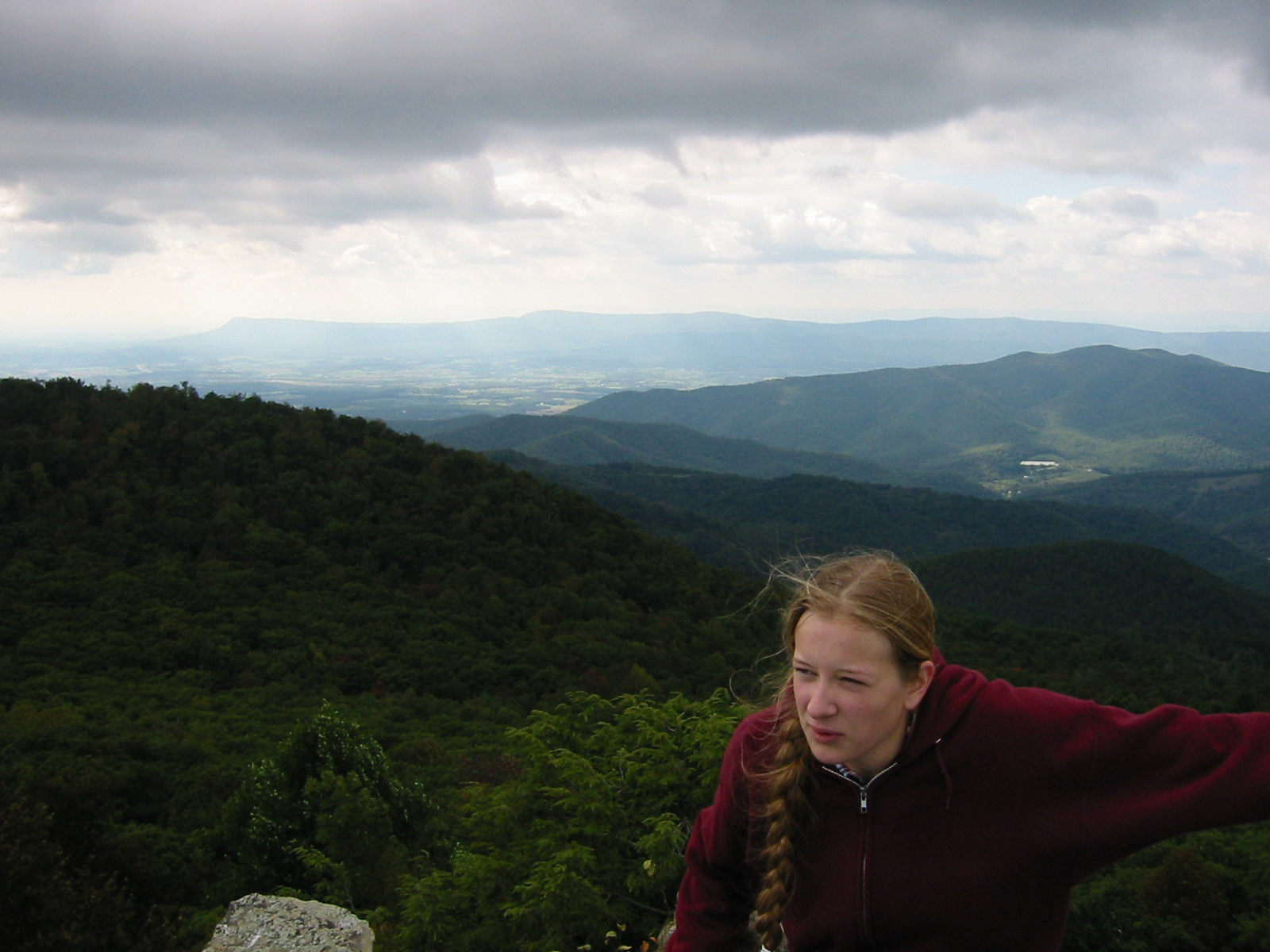Photo of a young woman in front of a mountain vista